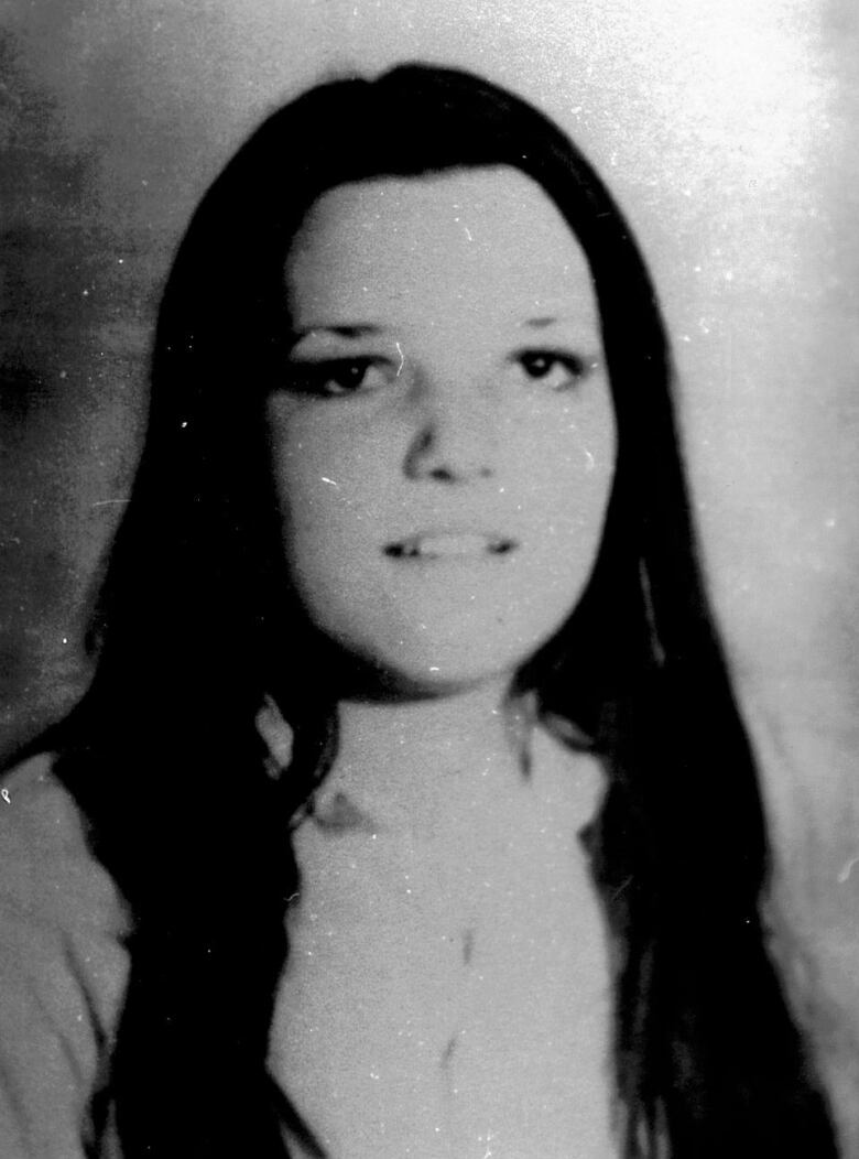 Black and white photo of a young woman with long dark hair.