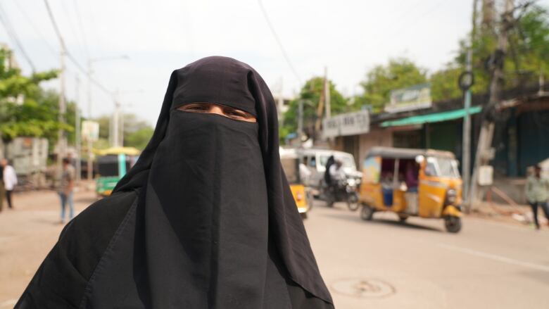 A woman in a black niqab.