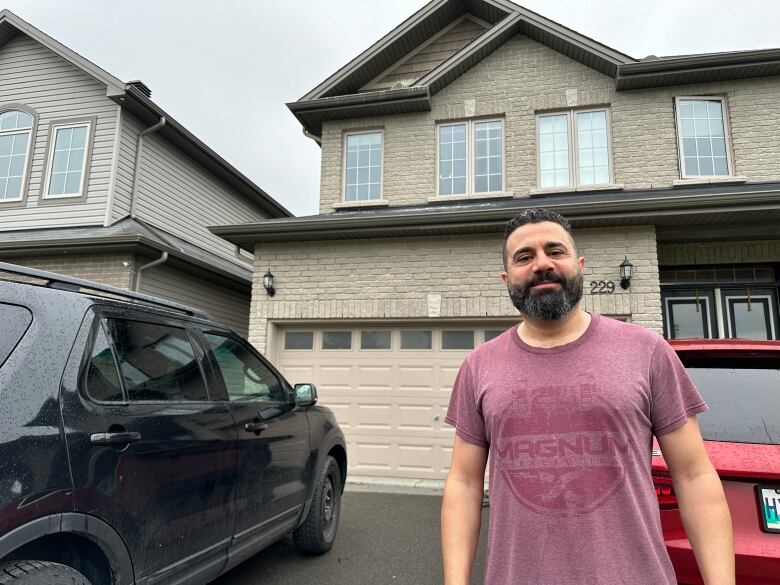 Sam Dalbah stands outside his Orleans home a few days after removing an empty raven's nest 