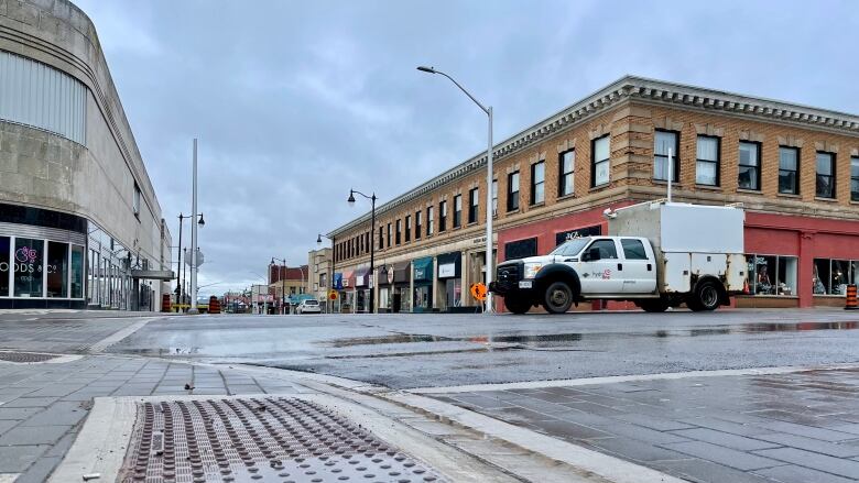 A truck drives through a wet intersection in Thunder Bay.