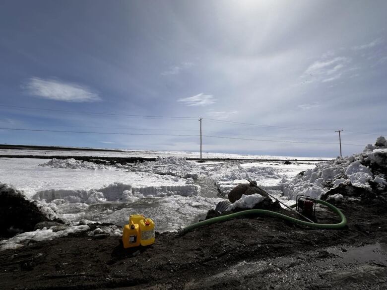 A hose attached into a river in Aupaluk. 