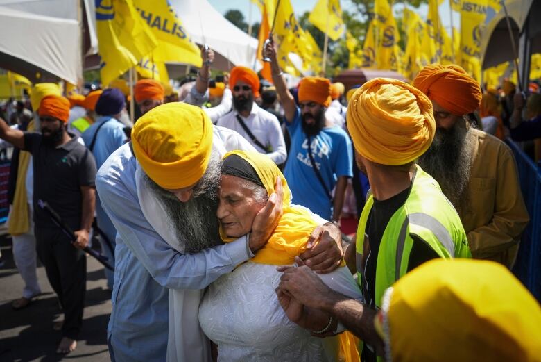 A woman is consoled as people mourn Sikh community leader and temple president Hardeep Singh Nijjar during Antim Darshan, the first part of day-long funeral services for him, in Surrey, British Columbia on Sunday, June 25, 2023.