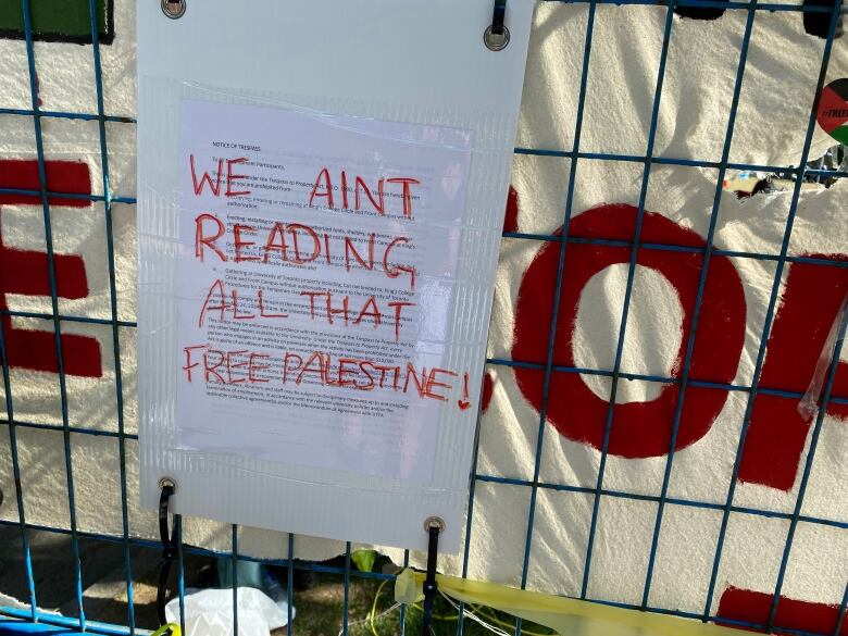 A University of Toronto trespass notice is defaced with the words 