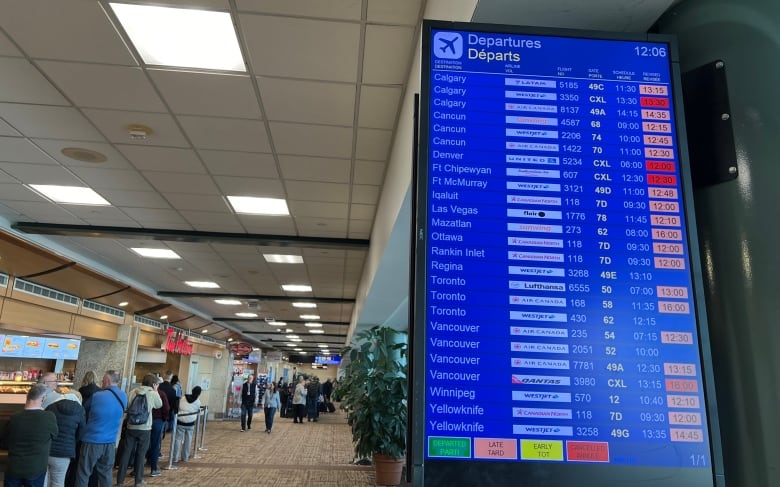 An arrivals /departures board at Edmonton International Airport on Friday 12 Jan 2024 shows many late flights listed.