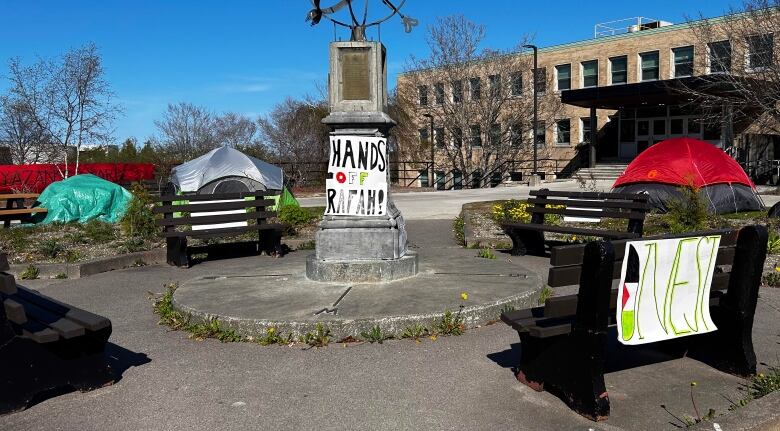 Statue with sign that reads 