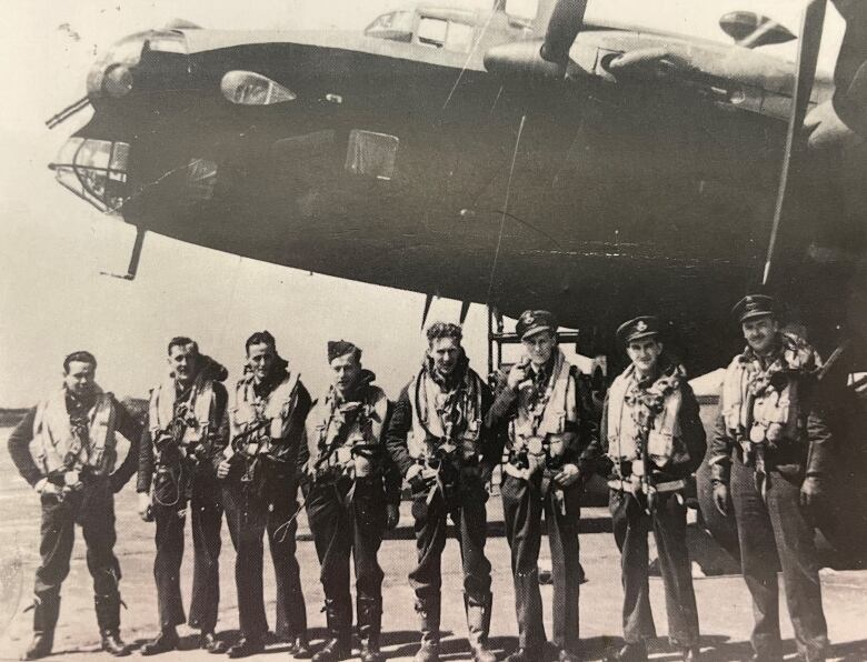 Angus MacLean and the seven other members of his crew pictured with their Halifax class bomber.