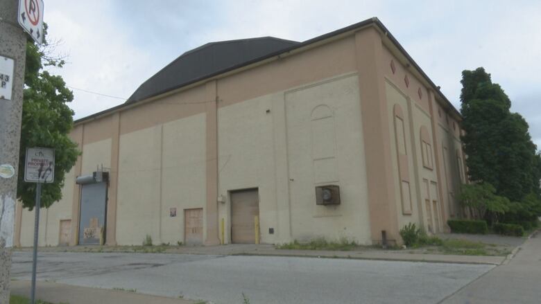 A hockey arena with boarded up entrances.