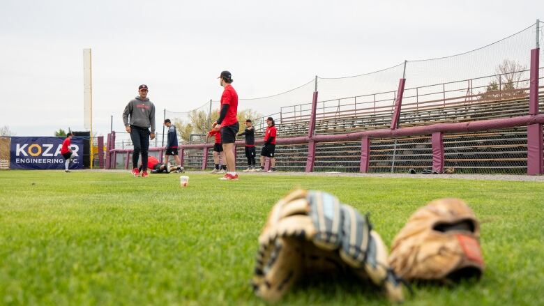 A baseball team practices on a field.