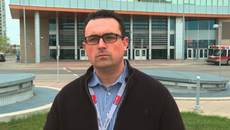 A man stands in front of the Westbrook transit station. 