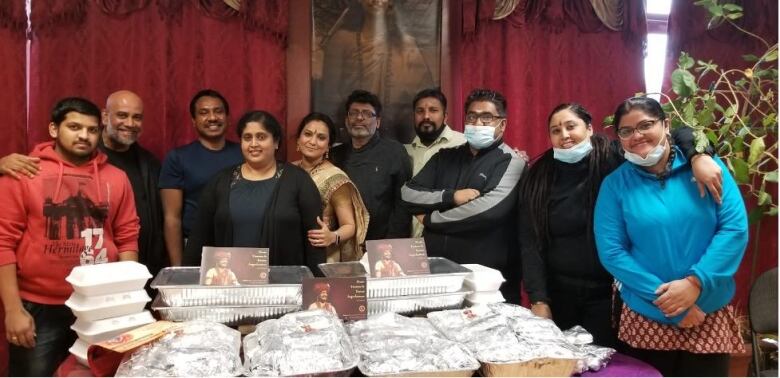 Members of Kailasa Canada pose with food prepared for donation in December, 2020.