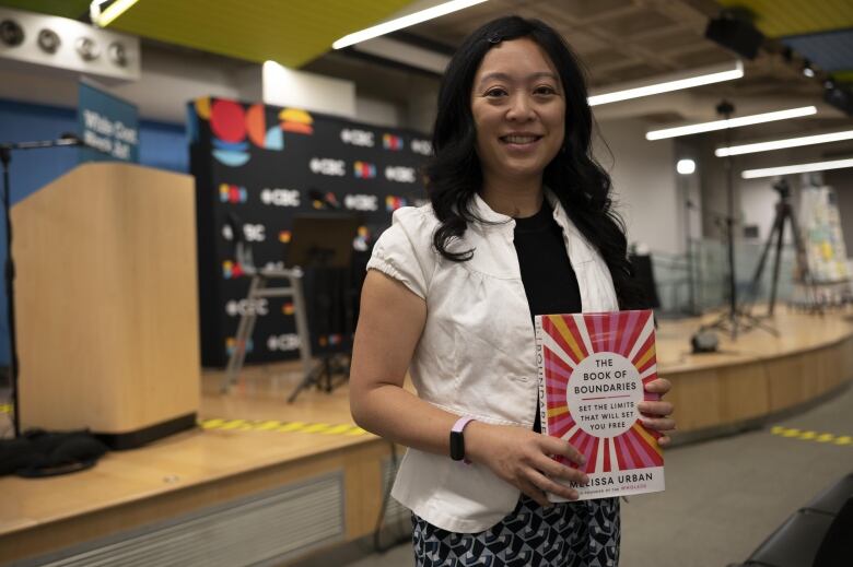 Sara Fung holds a copy of The Book of Boundaries by Melissa Urban.