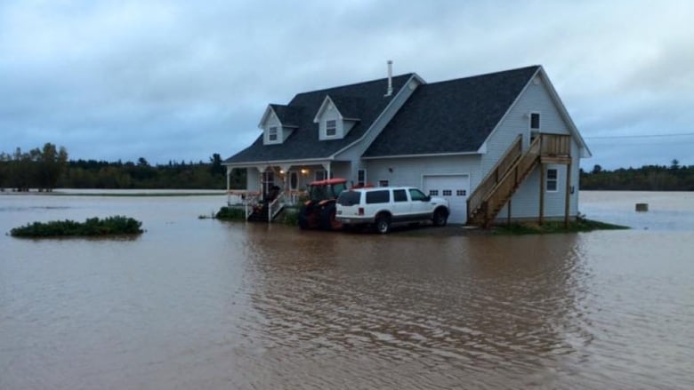 A mid-sized home with water surrounding it