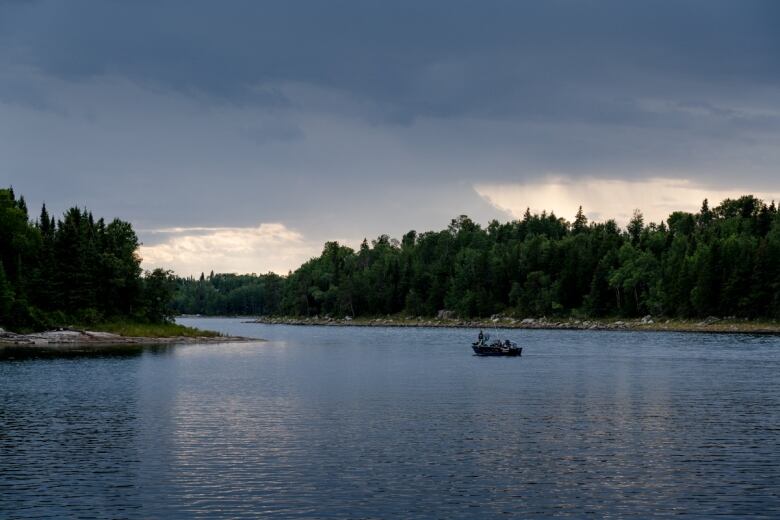 A boat is shown on a scenic river picture. 