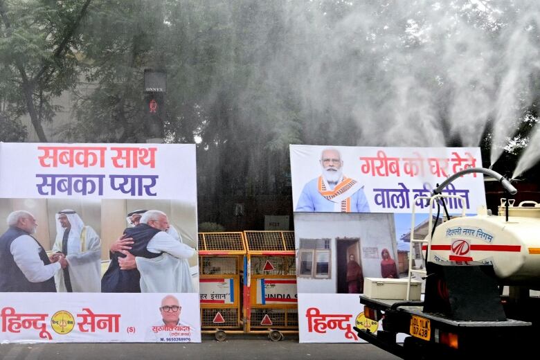 Several large placards are shown at the side of the road, with a spray of mist around them.