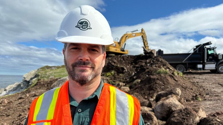 A man wearing a hard hat and safety gear. 