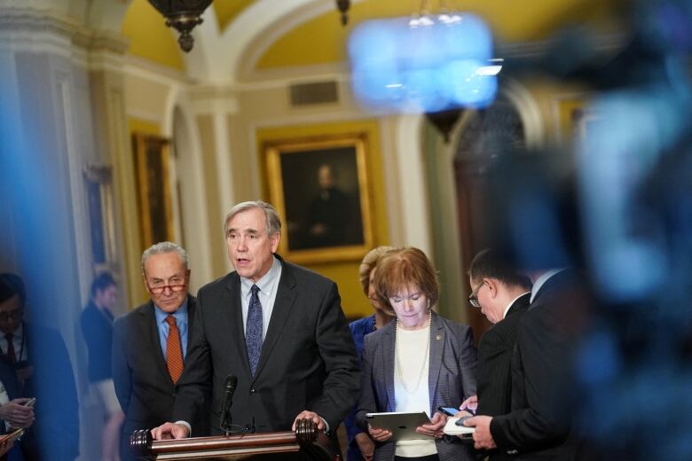 Man at lectern during news conference