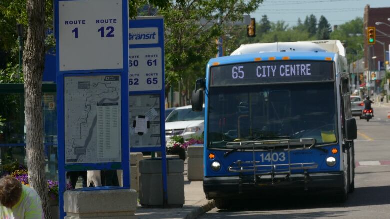 A Saskatoon Transit bus stops at a bus stop.