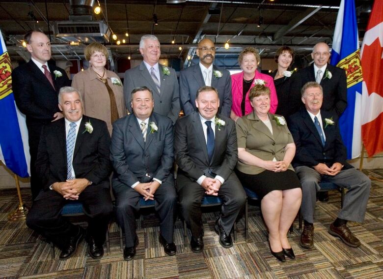 Two rows of people smiling for the camera.