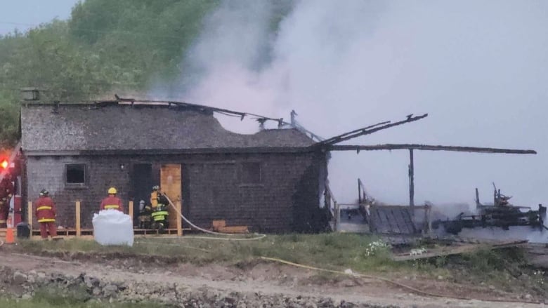 Fire crews are shown putting out a fire at a sawmill museum.