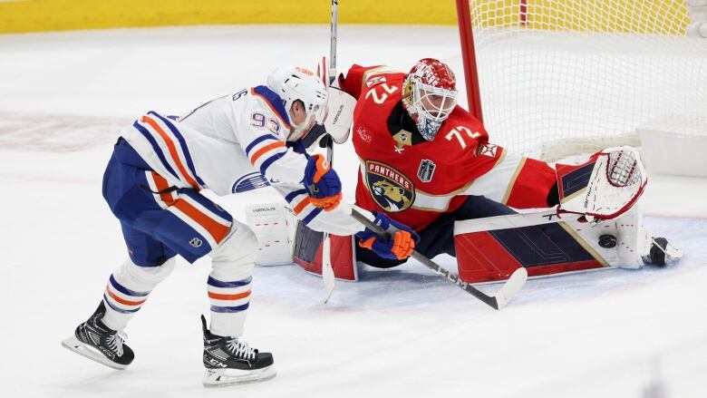 Florida Panthers male goalie makes a save against Oilers male player during the first period in Game One of the 2024 Stanley Cup final at Amerant Bank Arena on June 08, 2024 in Sunrise, Florida. 