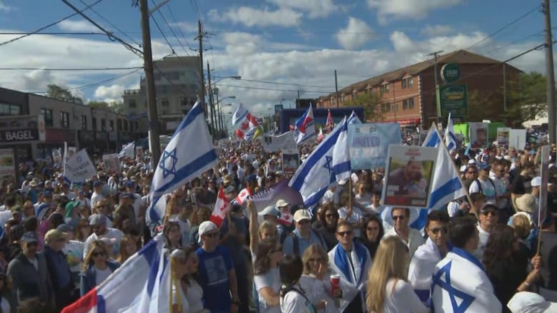 Protesters seen with Israeli flags.