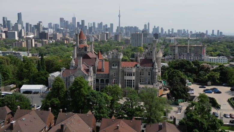 A shot of a castle and Toronto skyline.