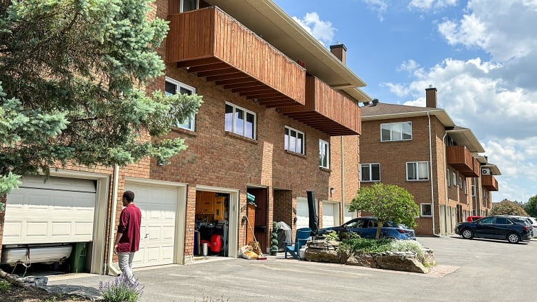 Jonathan Gibson Davis approaches the garage of the condo he bought during the pandemic.