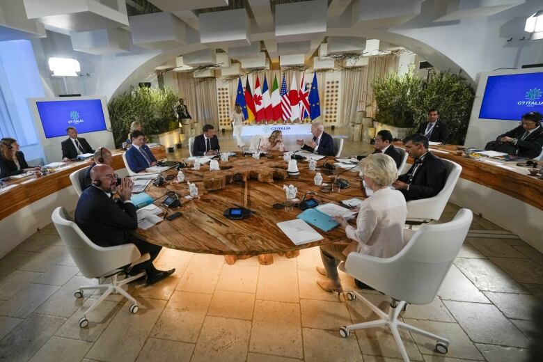 Clockwise from left, European Council President Charles Michel, German Chancellor Olaf Scholz, Canada's Prime Minister Justin Trudeau, French President Emmanuel Macron, Italian Prime Minister Giorgia Meloni, U.S. President Joe Biden, Japan's Prime Minister Fumio Kishida, Britain's Prime Minister Rishi Sunak and European Commission President Ursula von der Leyen participate in a working session during a G7 summit at Borgo Egnazia, Italy, Thursday, June 13, 2024. 