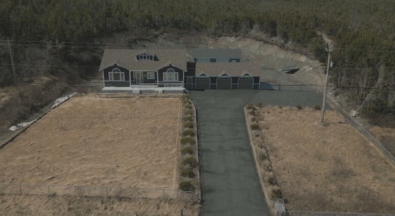 A large brown home with a three-car garage. 