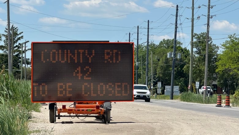 Sign announcing County Road 42's closure.