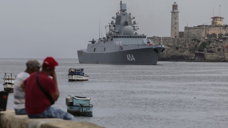 People watch the Russian Navy Admiral Gorshkov frigate arrive at the port of Havana, Cuba, Wednesday, June 12, 2024. A fleet of Russian warshipsreached Cuban waters on Wednesday ahead of planned military exercises in the Caribbean.