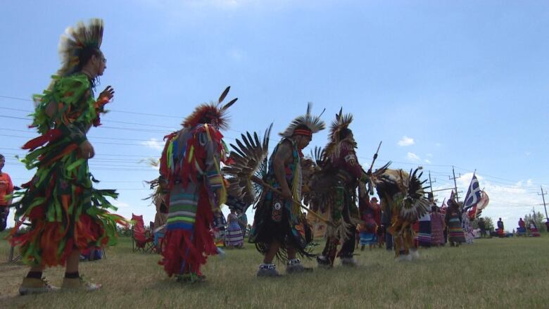 People in Indigenous regalia