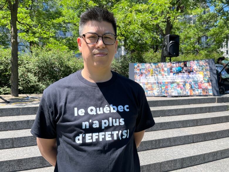 a man wears a black tee