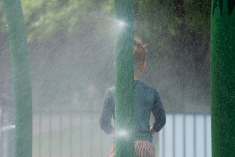 Child plays in the spray.