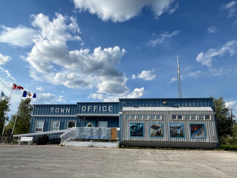 A town office building with clouds in the background 