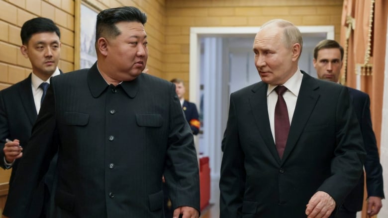 Russian President Vladimir Putin, right, and North Korea's leader Kim Jong Un talk to each other during their meeting in Pyongyang, North Korea, on Tuesday, June 18, 2024. 