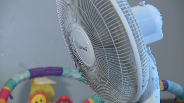 A fan oscillates inside a refugee support housing unit in Windsor, Ont. The building's AC unit has stopped working as a heat wave continues.