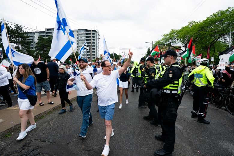 Pro-Israeli marchers react to Pro-Palestinian protesters gathered along the route of the United Jewish Appeals annual Walk With Israel march in Toronto, on Sunday, June 9, 2024.