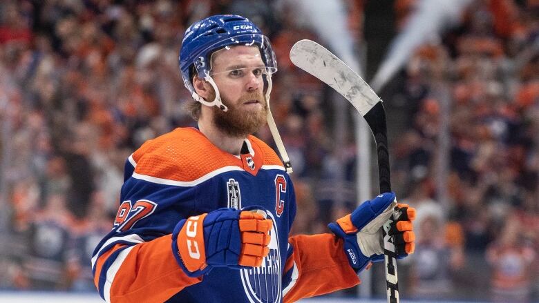 A men's hockey player celebrates after a game.