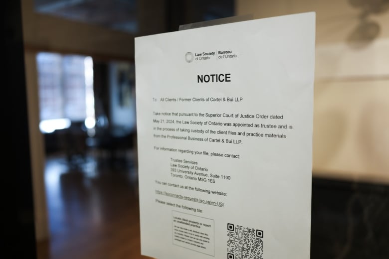 Photograph shows a notice posted on the door of the offices of defunct law firm Cartel & Bui LLP, in Toronto's Liberty Village, which announces that the Law Society of Ontario has taken over the firm's files and materials. 