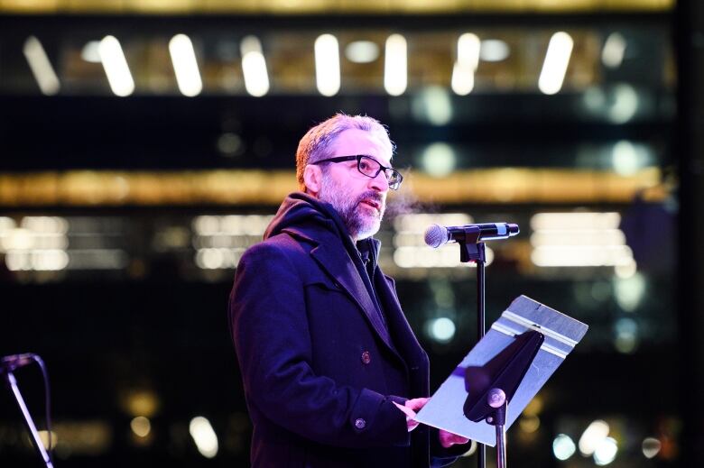 Hamed Esmaeilion speaks to a members of the Iranian community as they gather and grieve on the fourth anniversary of the downing of Ukraine International Airlines Flight PS752, in Toronto on Sunday, January 7, 2024.