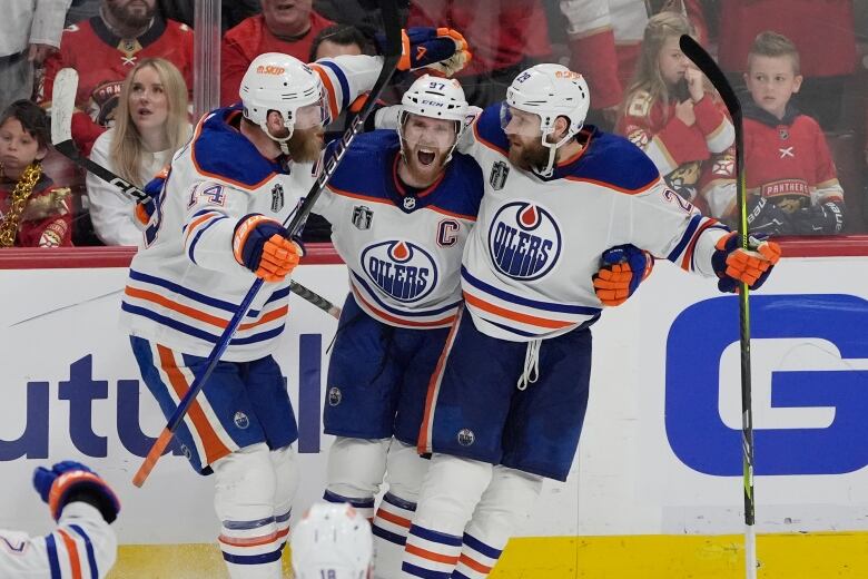 Hockey players celebrate a goal.