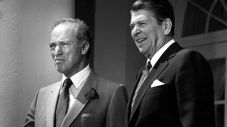 Black and white photo of Ronald Reagan and Pierre Trudeau standing next to each other