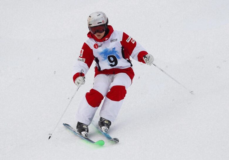 A skier skis down a hill.