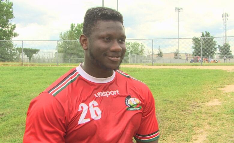 A man wearing a red soccer jersey.