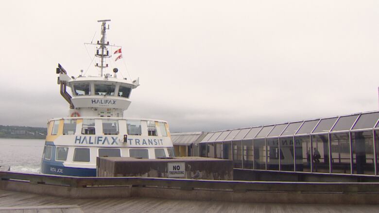 A Halifax Transit ferry is docked next to the terminal in the Halifax Harbour. 