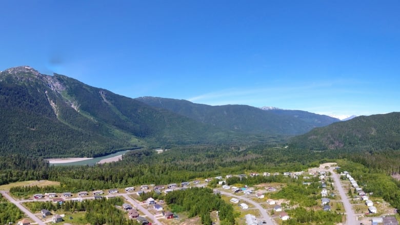 An aerial image of a valley community framed by mountains.