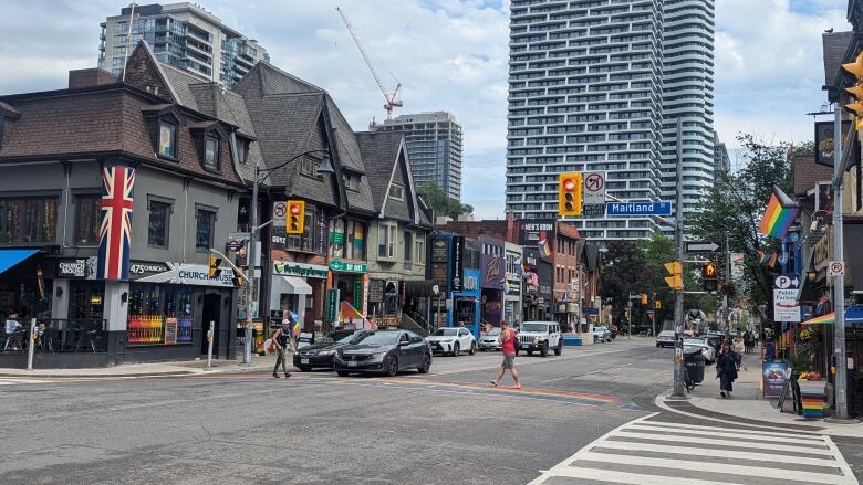 Pedestrians use a crosswalk painted in the Pride flag colours along a stretch of Church Street.