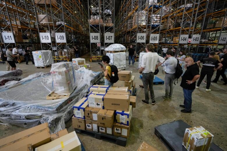 Journalists are given a tour inside a cargo center at the Rafik Hariri International Airport in Beirut, Lebanon, Monday, June 24, 2024. The tour comes a day after a British newspaper published a story, citing anonymous airport workers, claiming that Hezbollah is storing weapons at the airport. Clashes with the Israeli military on the Lebanon-Israel border have significantly escalated in recent weeks.