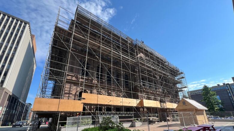 Scaffolding around a building in a downtown area.